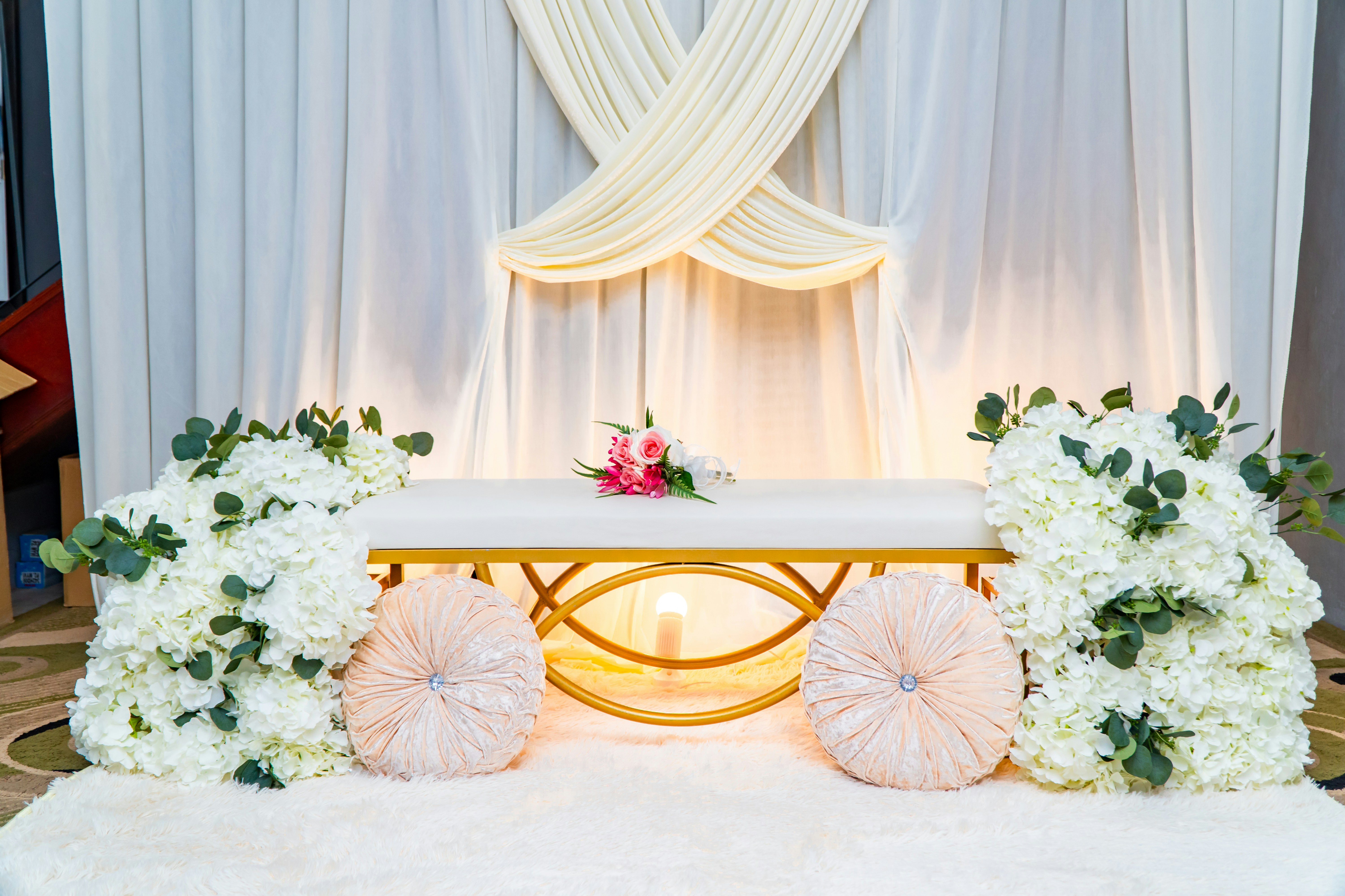 Luxury ivory decor stage with florals and warm lighting